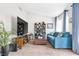Living room features a comfortable blue sofa, vaulted ceilings, and decorative shelving at 9445 Grand Mesa Dr, Las Vegas, NV 89134