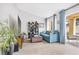 Living room with vaulted ceilings, a blue sofa, and sliding doors to the patio at 9445 Grand Mesa Dr, Las Vegas, NV 89134