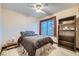 Bedroom with ceiling fan, window, and built-in shelves, creating a cozy retreat at 9921 Heffner Hills Cir, Las Vegas, NV 89117