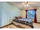 Comfortable bedroom featuring a large window, soft lighting, and stylish decor at 9921 Heffner Hills Cir, Las Vegas, NV 89117