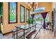 Bright dining area with large windows, stylish table, and view of the backyard pool and patio at 9921 Heffner Hills Cir, Las Vegas, NV 89117