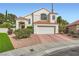 Charming two-story home featuring a white stucco facade, clay tile roof, and well-maintained landscaping at 9921 Heffner Hills Cir, Las Vegas, NV 89117