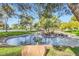 Charming community pond featuring rock details, mini-waterfalls, and scenic green surroundings at 9921 Heffner Hills Cir, Las Vegas, NV 89117