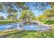 Picturesque pond with rock features and waterfalls, surrounded by lush trees and landscaping at 9921 Heffner Hills Cir, Las Vegas, NV 89117