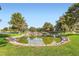 Peaceful pond framed by manicured lawns and mature trees within the community at 9921 Heffner Hills Cir, Las Vegas, NV 89117