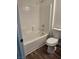 Bright bathroom featuring a white tiled shower-tub combination and modern toilet at 1040 Karen Ct, Pahrump, NV 89048