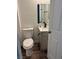 Bathroom features a toilet, white vanity with countertop, and a matte black faucet at 1040 Karen Ct, Pahrump, NV 89048