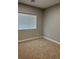 This bedroom features a bright window with blinds and neutral carpet at 1040 Karen Ct, Pahrump, NV 89048