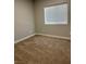 Cozy bedroom features neutral walls and a large window that provides plenty of natural light at 1040 Karen Ct, Pahrump, NV 89048