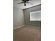 Bedroom with ceiling fan, bright window, and neutral carpet at 1040 Karen Ct, Pahrump, NV 89048