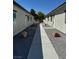 Between units, featuring a concrete walkway with decorative gravel and desert landscaping at 1040 Karen Ct, Pahrump, NV 89048