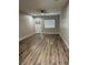 Bright living room with natural light and wood-look floors at 1040 Karen Ct, Pahrump, NV 89048