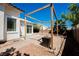 Private backyard featuring a stone patio and wooden pergola, perfect for outdoor living at 10404 Shadowland Ave, Las Vegas, NV 89144