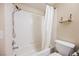 This bright bathroom has a shower-tub combo with white tile and modern fixtures at 10404 Shadowland Ave, Las Vegas, NV 89144