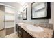 Bathroom featuring dual sinks, granite countertops, and an adjacent closet at 10404 Shadowland Ave, Las Vegas, NV 89144