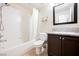 This bathroom offers a shower-tub combo and a vanity with a granite countertop at 10404 Shadowland Ave, Las Vegas, NV 89144