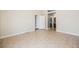 A bright bedroom featuring tile flooring, neutral walls, and an adjacent bathroom at 10404 Shadowland Ave, Las Vegas, NV 89144