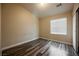 This bedroom boasts a window and wood-look floors providing style and natural light at 10404 Shadowland Ave, Las Vegas, NV 89144