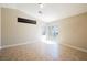A bright bedroom features tile flooring, neutral walls, and a sliding glass door leading to the backyard at 10404 Shadowland Ave, Las Vegas, NV 89144