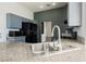 Kitchen with undermount sink, gray cabinets, granite counters, and appliances at 10404 Shadowland Ave, Las Vegas, NV 89144