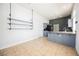 Spacious kitchen area with tile flooring, shelving, and stainless appliances at 10404 Shadowland Ave, Las Vegas, NV 89144