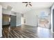 Spacious living room featuring sleek hardwood floors, modern lighting, and a sliding glass door at 10404 Shadowland Ave, Las Vegas, NV 89144