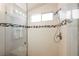 Modern shower featuring custom tile, rainfall showerhead, and built-in niche at 10404 Shadowland Ave, Las Vegas, NV 89144