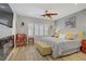 Comfortable bedroom with decorative ceiling fan, stylish decor, and plenty of natural light at 11249 Revelry Ln, Las Vegas, NV 89138
