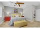 Comfortable bedroom with a ceiling fan, wood floors, and stylish furniture at 11249 Revelry Ln, Las Vegas, NV 89138