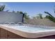Relaxing hot tub with water features and tropical plants in a backyard oasis at 11249 Revelry Ln, Las Vegas, NV 89138