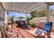 Cozy outdoor patio area with a hot tub, mature trees, and a shaded seating area at 11249 Revelry Ln, Las Vegas, NV 89138