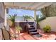 Comfortable backyard patio with a hot tub, seating area, and overhead pergola at 11249 Revelry Ln, Las Vegas, NV 89138