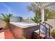 Secluded backyard hot tub featuring a wood-look exterior and easy access steps at 11249 Revelry Ln, Las Vegas, NV 89138