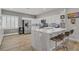 Bright kitchen with a marble countertop island, stainless steel appliances, and sleek white cabinetry at 11249 Revelry Ln, Las Vegas, NV 89138