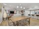 Spacious open floor plan featuring a living room with modern lighting and an adjoining kitchen at 11249 Revelry Ln, Las Vegas, NV 89138