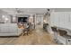 Spacious living room with wood look flooring, modern decor, and seamless access to the kitchen at 11249 Revelry Ln, Las Vegas, NV 89138