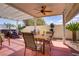Outdoor patio area with dining table, seating, and a relaxing hot tub feature at 11249 Revelry Ln, Las Vegas, NV 89138
