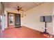 Covered back patio with ceiling fan and access to the backyard and outdoor areas at 11249 Revelry Ln, Las Vegas, NV 89138