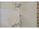 Modern shower features chrome hardware, rainfall shower head and tile surround at 11249 Revelry Ln, Las Vegas, NV 89138