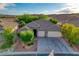 A stunning aerial view showcases a home's beautiful roof, manicured landscaping, and a spacious two-car garage at 1153 Mesa Verde Run, Mesquite, NV 89027