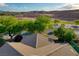 This aerial view shows a house with lush greenery, mountain views, and a well-maintained neighborhood at 1153 Mesa Verde Run, Mesquite, NV 89027