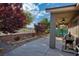 A covered back patio features an outdoor kitchen area with a built-in grill and views of the landscaped backyard at 1153 Mesa Verde Run, Mesquite, NV 89027