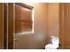 A powder room with a toilet near a window at 1153 Mesa Verde Run, Mesquite, NV 89027