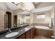 Bathroom with double sinks, soaking tub, granite counters, and tiled flooring at 1153 Mesa Verde Run, Mesquite, NV 89027