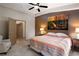 A bedroom with a ceiling fan, carpeted floors, and view of the bathroom at 1153 Mesa Verde Run, Mesquite, NV 89027
