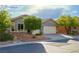 Traditional home with desert landscaping, a two-car garage, and a cozy, inviting front entrance at 1153 Mesa Verde Run, Mesquite, NV 89027