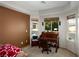 Inviting home office with a classic wooden desk and ample natural light from the windows at 1153 Mesa Verde Run, Mesquite, NV 89027
