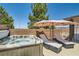 Backyard spa with seating, an umbrella, and partial privacy wall at 1197 Bear Head St, Henderson, NV 89011