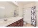 Neutral toned bathroom featuring a single sink vanity and shower-tub combo at 1197 Bear Head St, Henderson, NV 89011