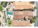 An aerial view showcases the tiled roofs and private pools of closely situated neighborhood homes at 12 Via Ravello, Henderson, NV 89011